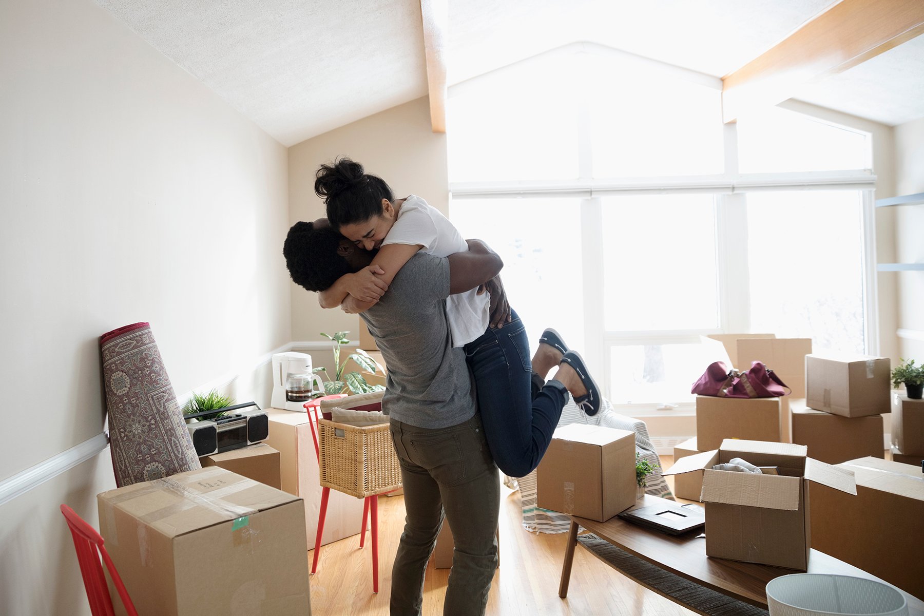 Stock photo of mixed race young couple celebrating new home
